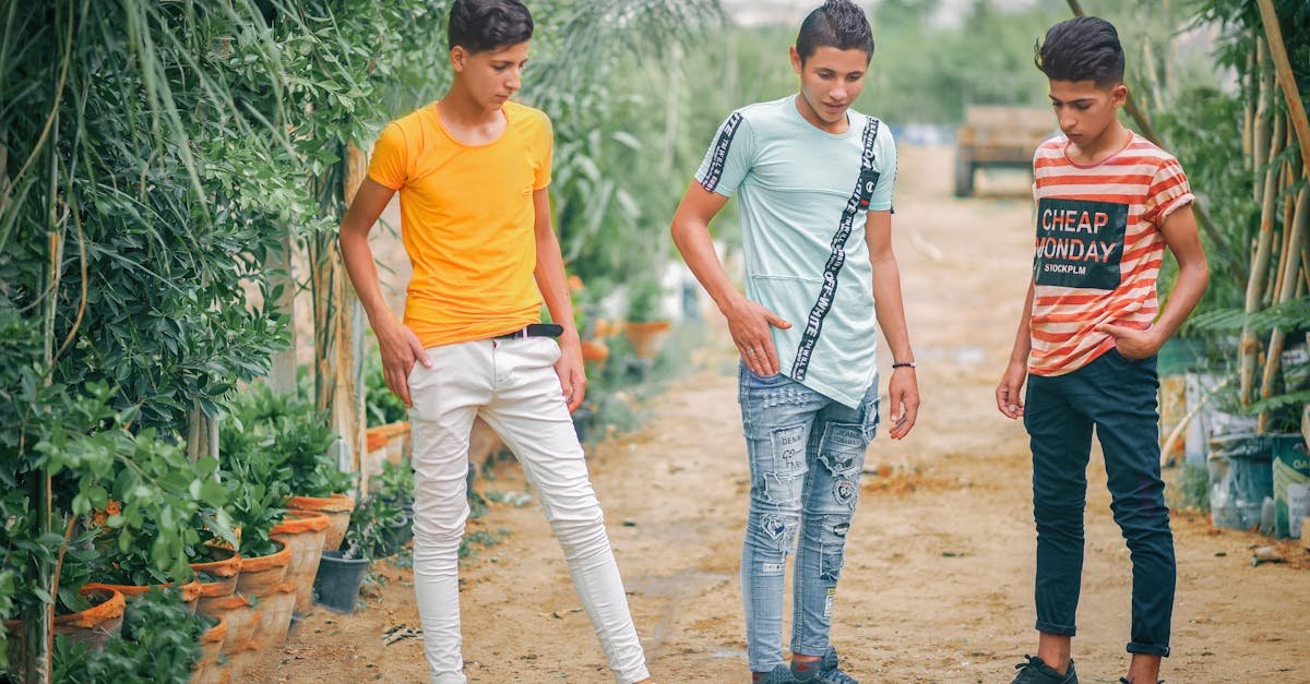 Three teenage boys enjoying a fun day outdoors, expressing friendship and leisure.